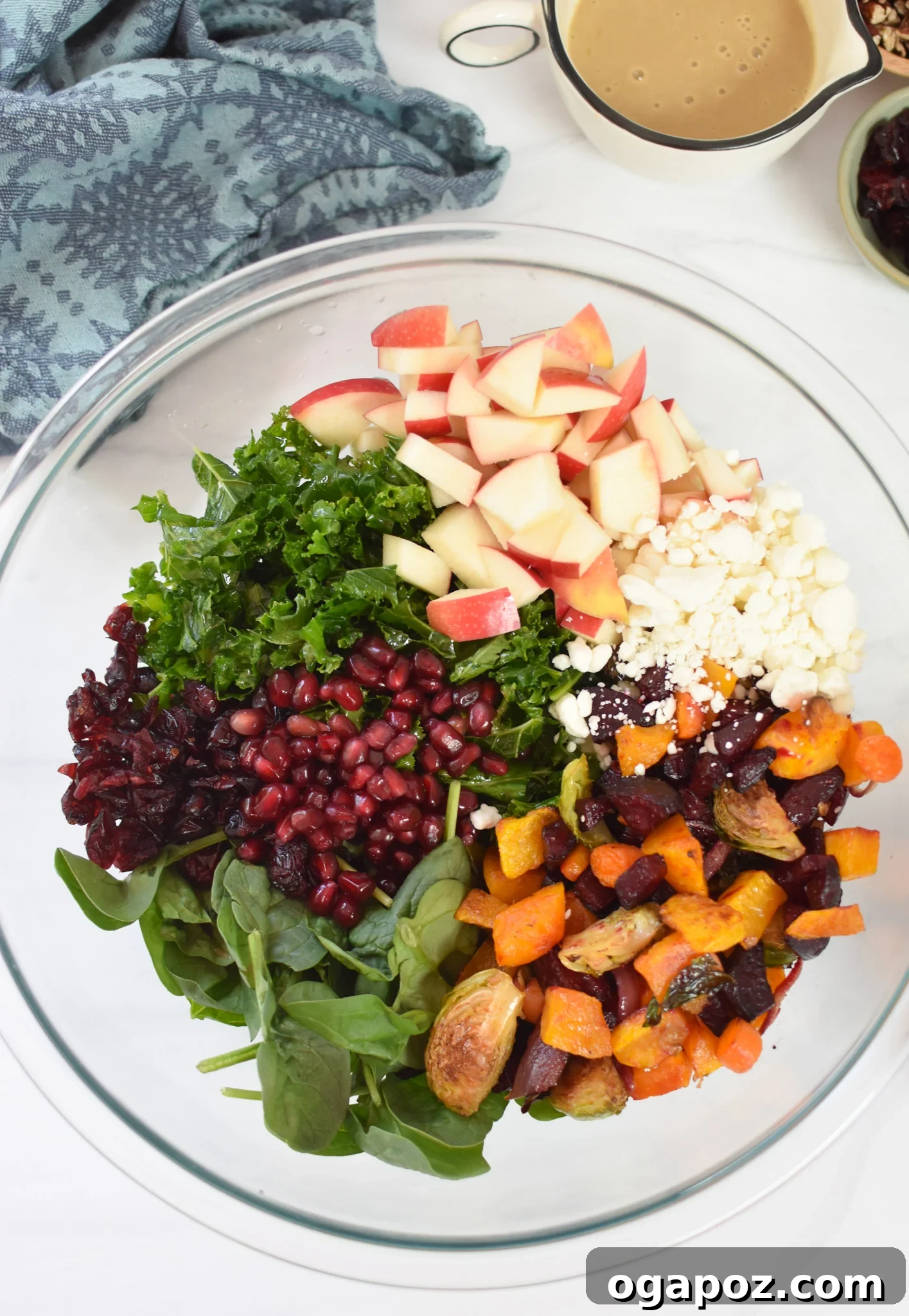 Golden Harvest Salad 8 Fresh Fall Harvest Salad ingredients like kale, spinach, apple, pecans, and cranberries mixed in a bowl.