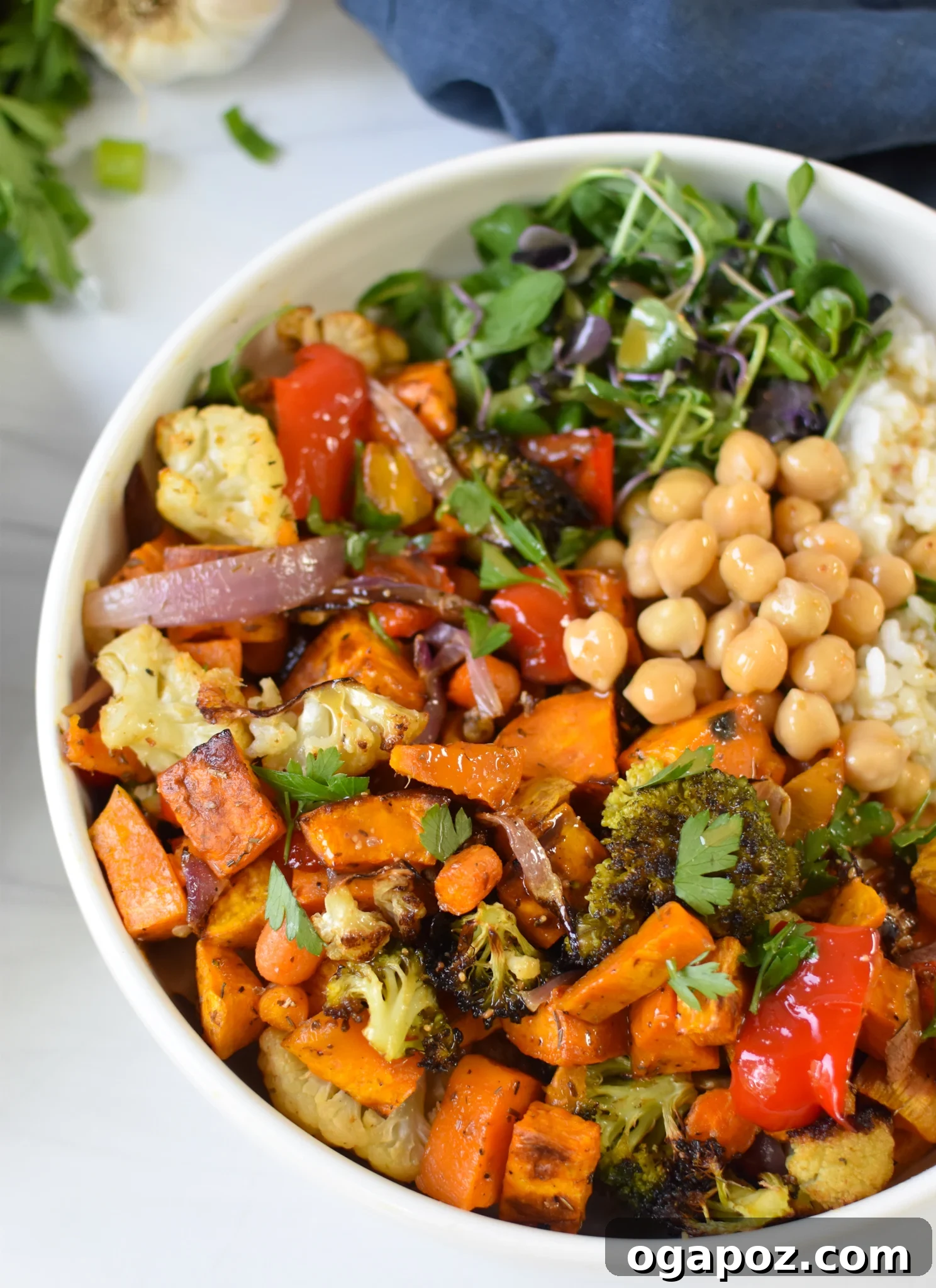 Wholesome Sweet Potato Bowl 2 Vibrant Sweet Potato Buddha Bowl with roasted vegetables and tahini dressing in a white ceramic bowl.