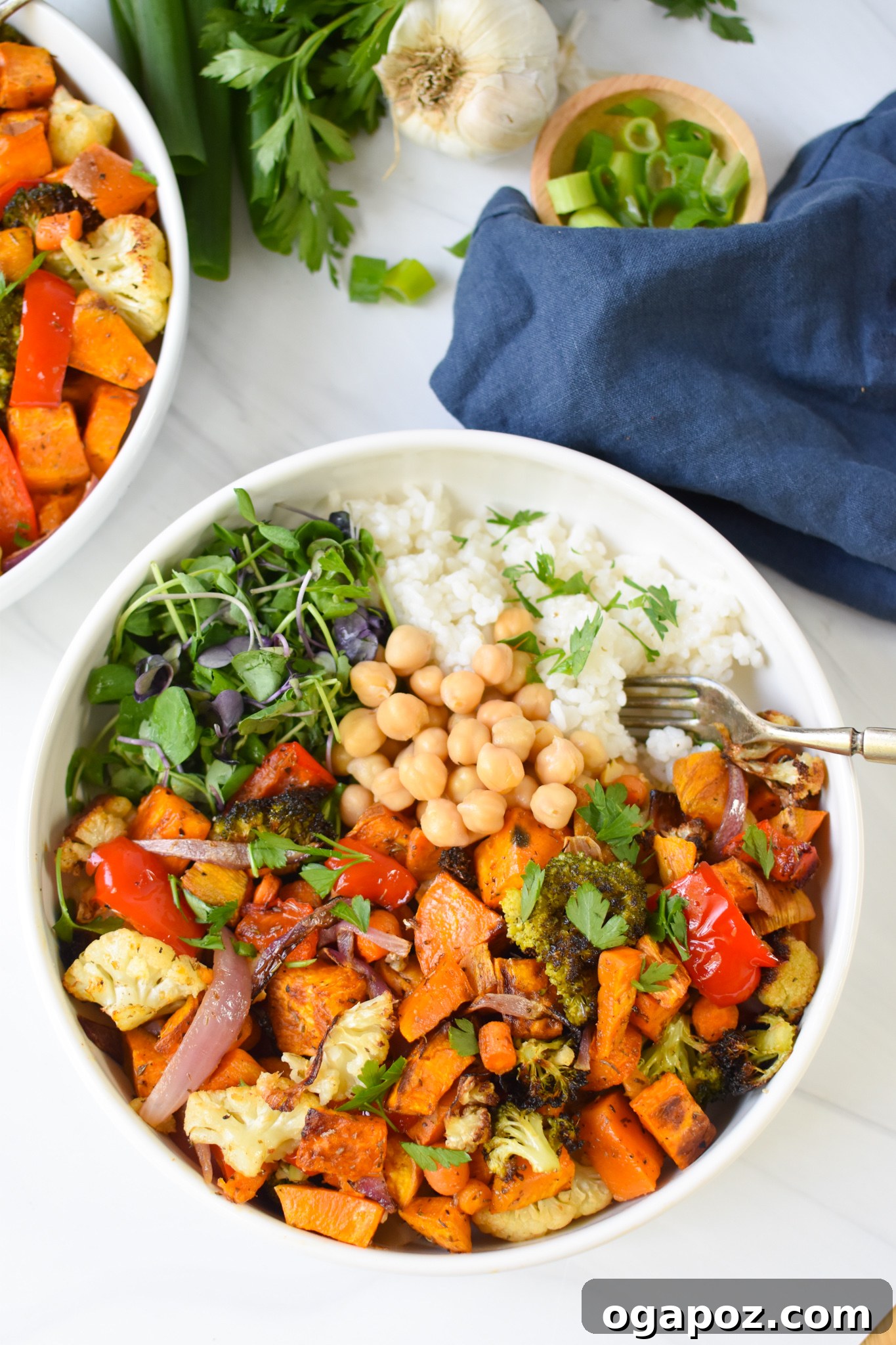 Wholesome Sweet Potato Bowl 4 A close-up shot of a Sweet Potato Bowl with a fork, showing the texture and combination of roasted vegetables, grains, and chickpeas, ready to be enjoyed.