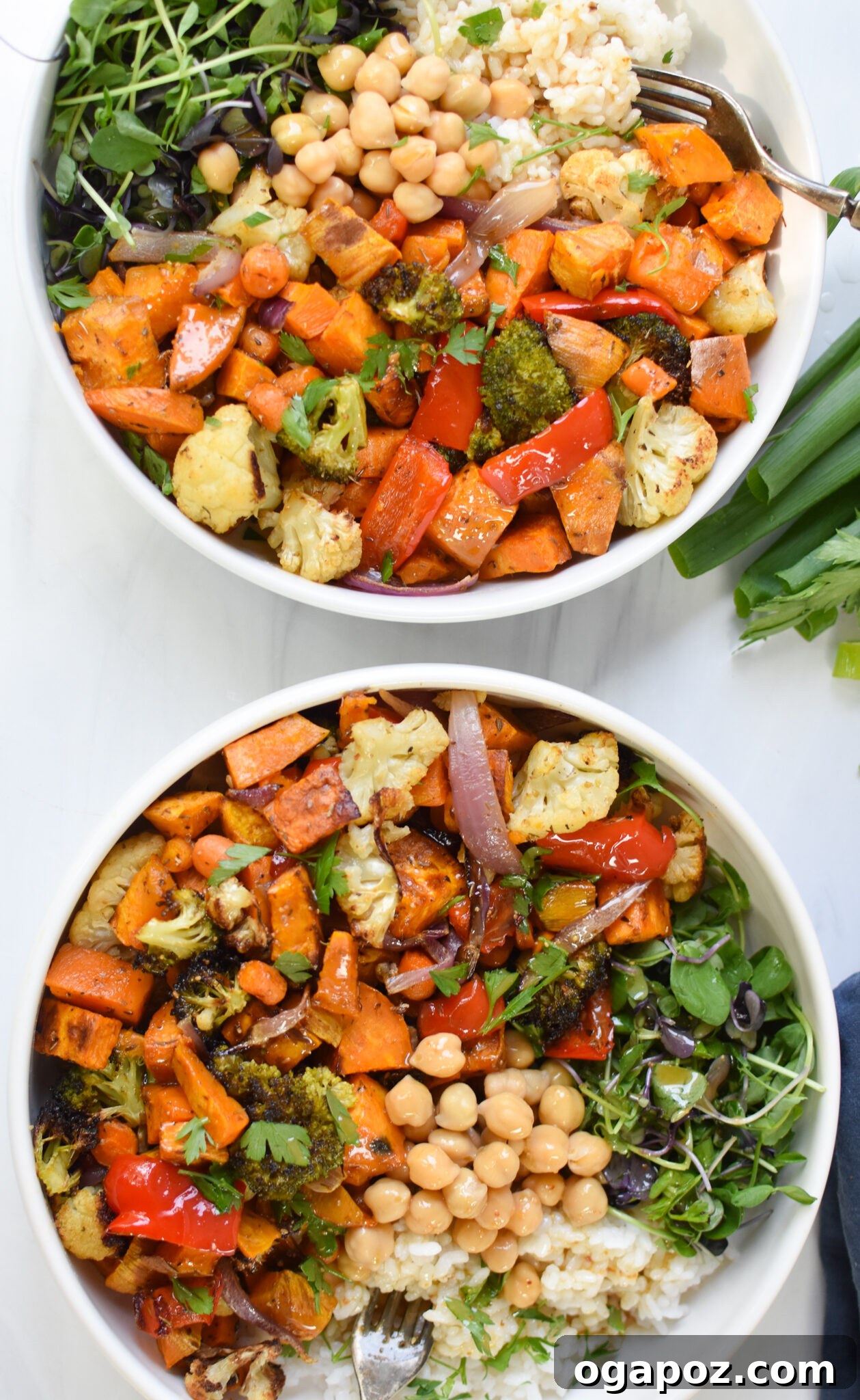Wholesome Sweet Potato Bowl 8 Two beautifully assembled Sweet Potato Bowls, each featuring a base of grains, a generous portion of roasted sweet potatoes and vegetables, chickpeas, and a drizzle of tahini dressing, ready for serving.