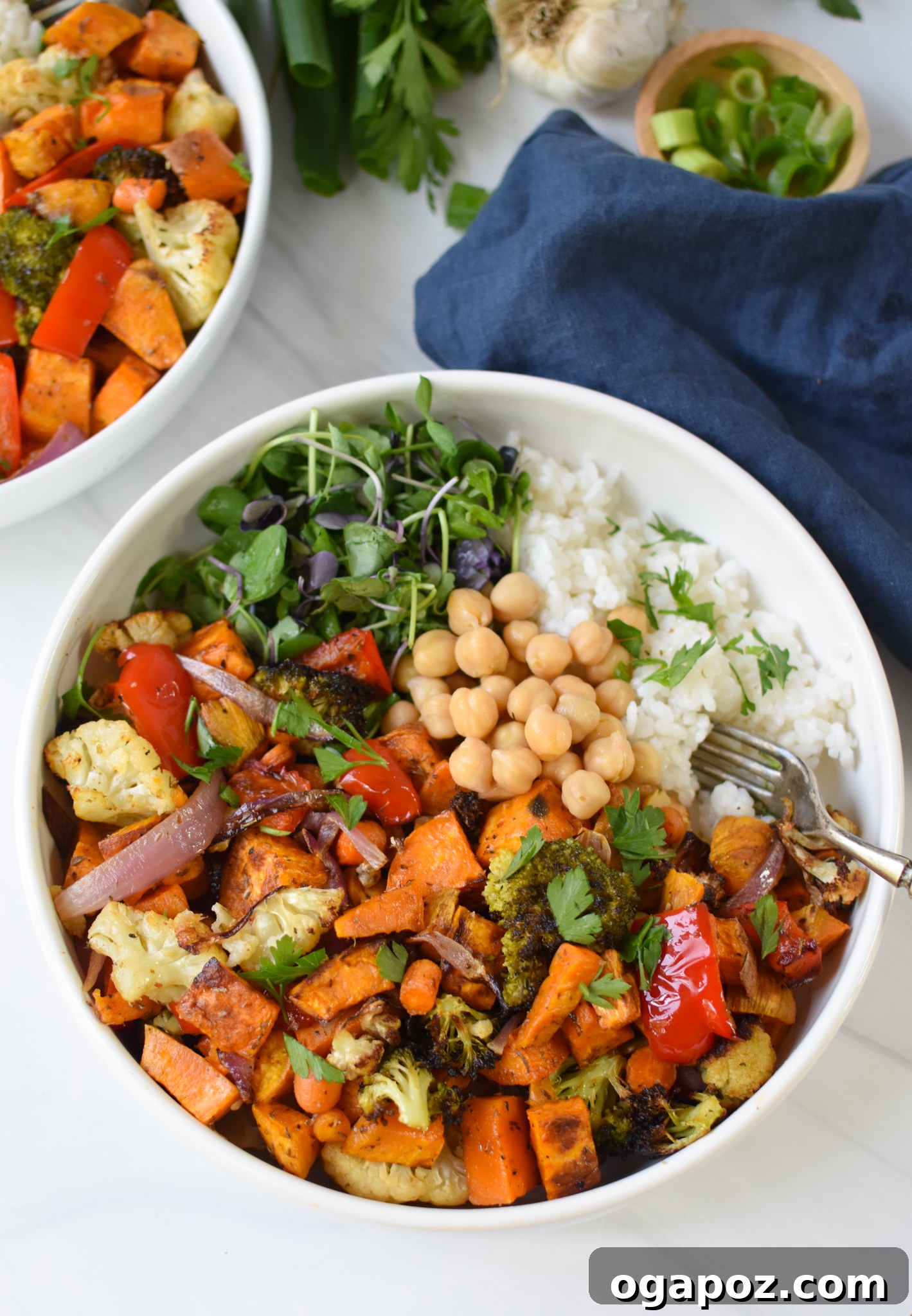 Wholesome Sweet Potato Bowl 9 A close-up of chickpeas nestled among roasted vegetables and grains in a Sweet Potato Bowl, highlighting the protein component.
