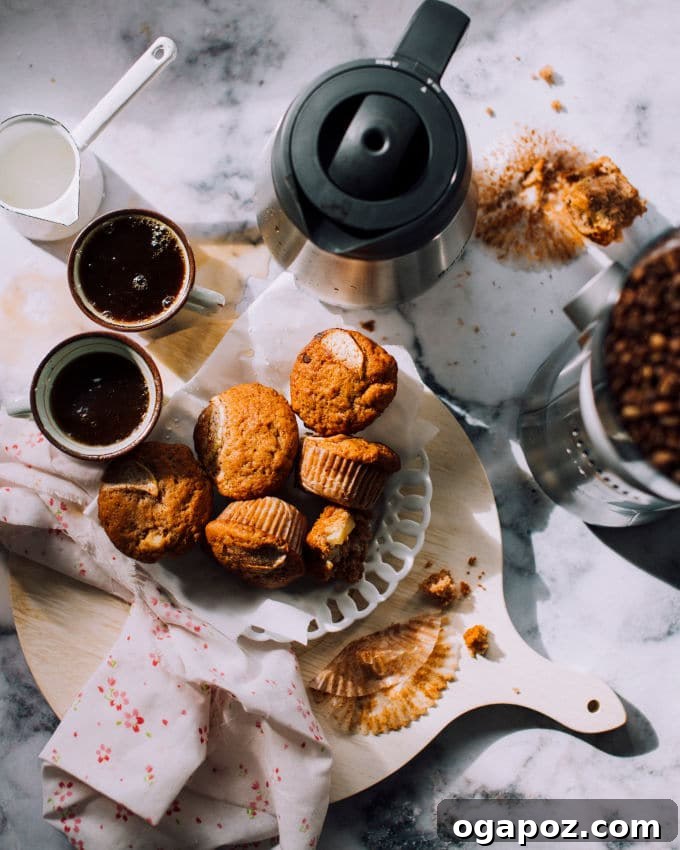 Spiced Apple Cinnamon Muffins 4 Plate of Apple Cinnamon Muffins served with a cup of coffee.