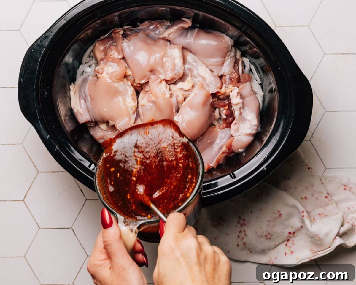 Melt-in-Your-Mouth Slow Cooker BBQ Chicken 6 Step 3: Whisking together all the BBQ sauce ingredients in a mixing bowl for Crockpot BBQ Chicken.