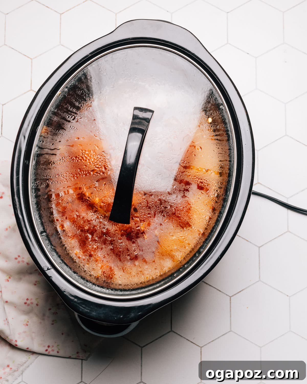 Melt-in-Your-Mouth Slow Cooker BBQ Chicken 7 Step 4: Pouring the homemade BBQ sauce evenly over the chicken and onions in the slow cooker.