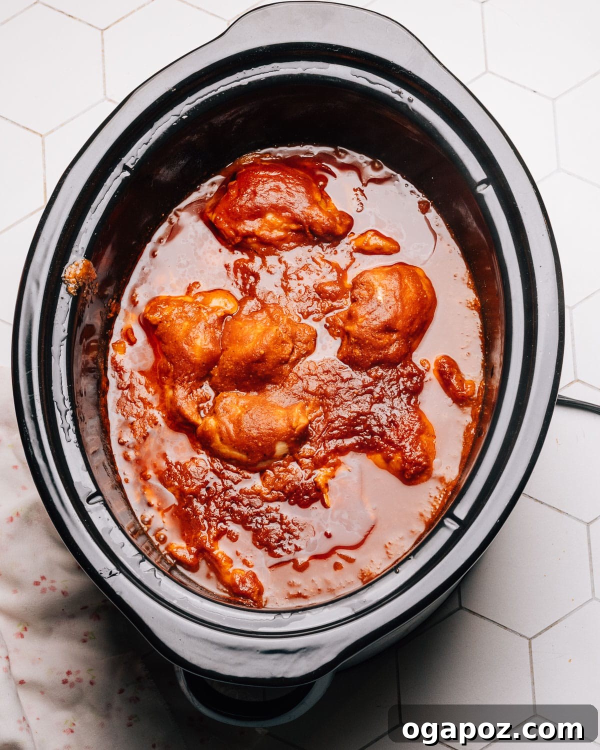 Melt-in-Your-Mouth Slow Cooker BBQ Chicken 8 Step 5: Shredding the cooked, tender Crockpot BBQ Chicken with two forks on a cutting board.