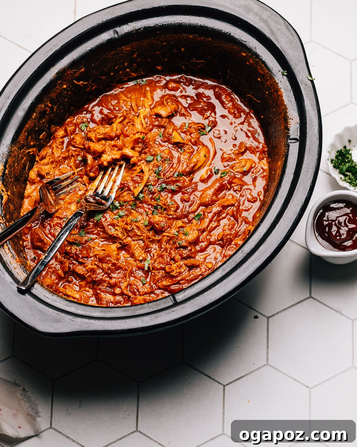Melt-in-Your-Mouth Slow Cooker BBQ Chicken 9 Step 6: Stirring the shredded BBQ chicken back into the sauce in the slow cooker for the final delicious coating.