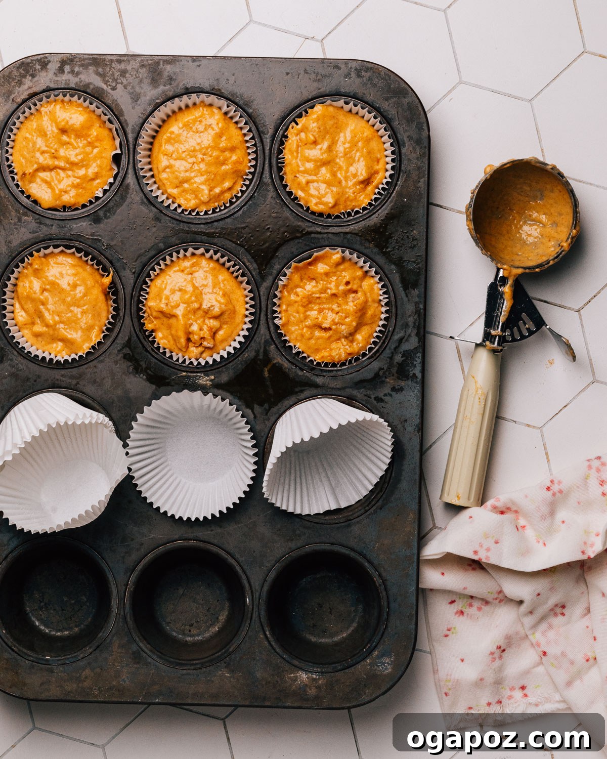 Spiced Pumpkin Banana Muffins 7 Step 4: Pumpkin banana muffin batter portioned into muffin liners, ready for baking.