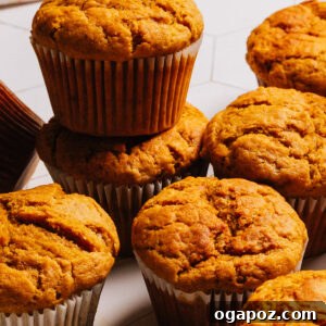 Beautifully baked Pumpkin Banana Muffins cooling on a rack, showcasing their fluffy texture.