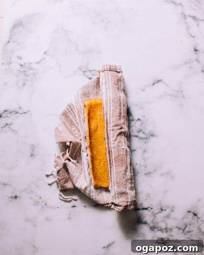 Image showing how to invert warm pumpkin cake onto a sugared towel.