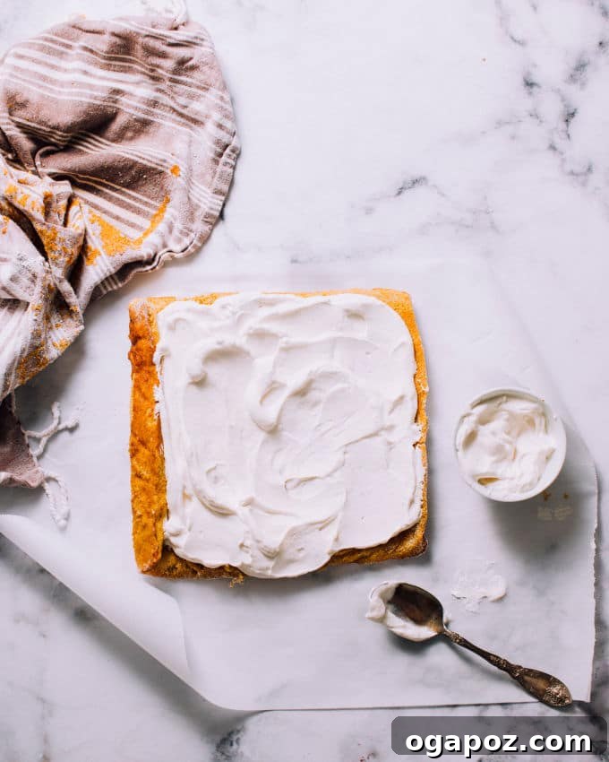 Image demonstrating peeling parchment paper off the pumpkin cake.