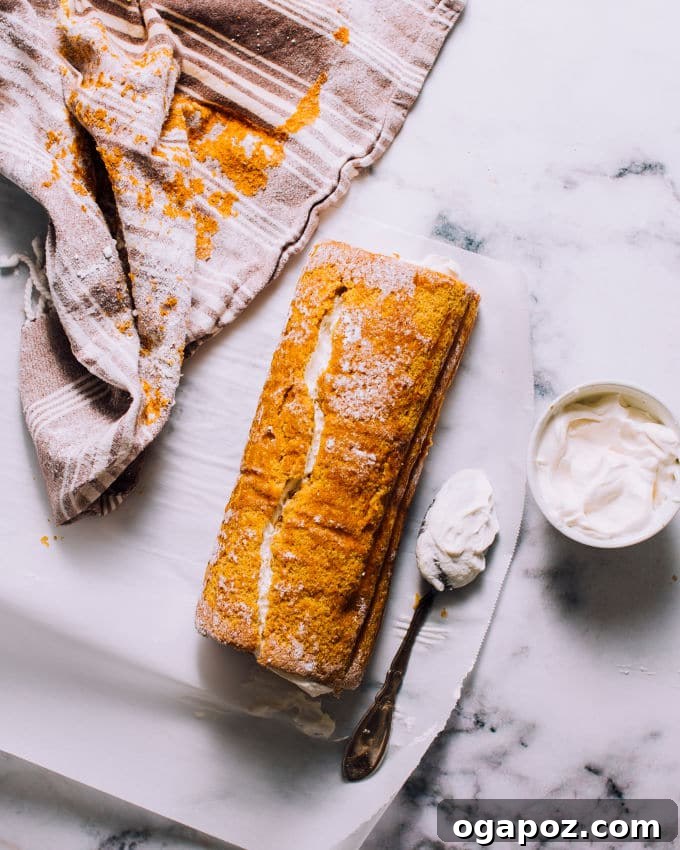 How to roll a pumpkin cake with a towel while warm.