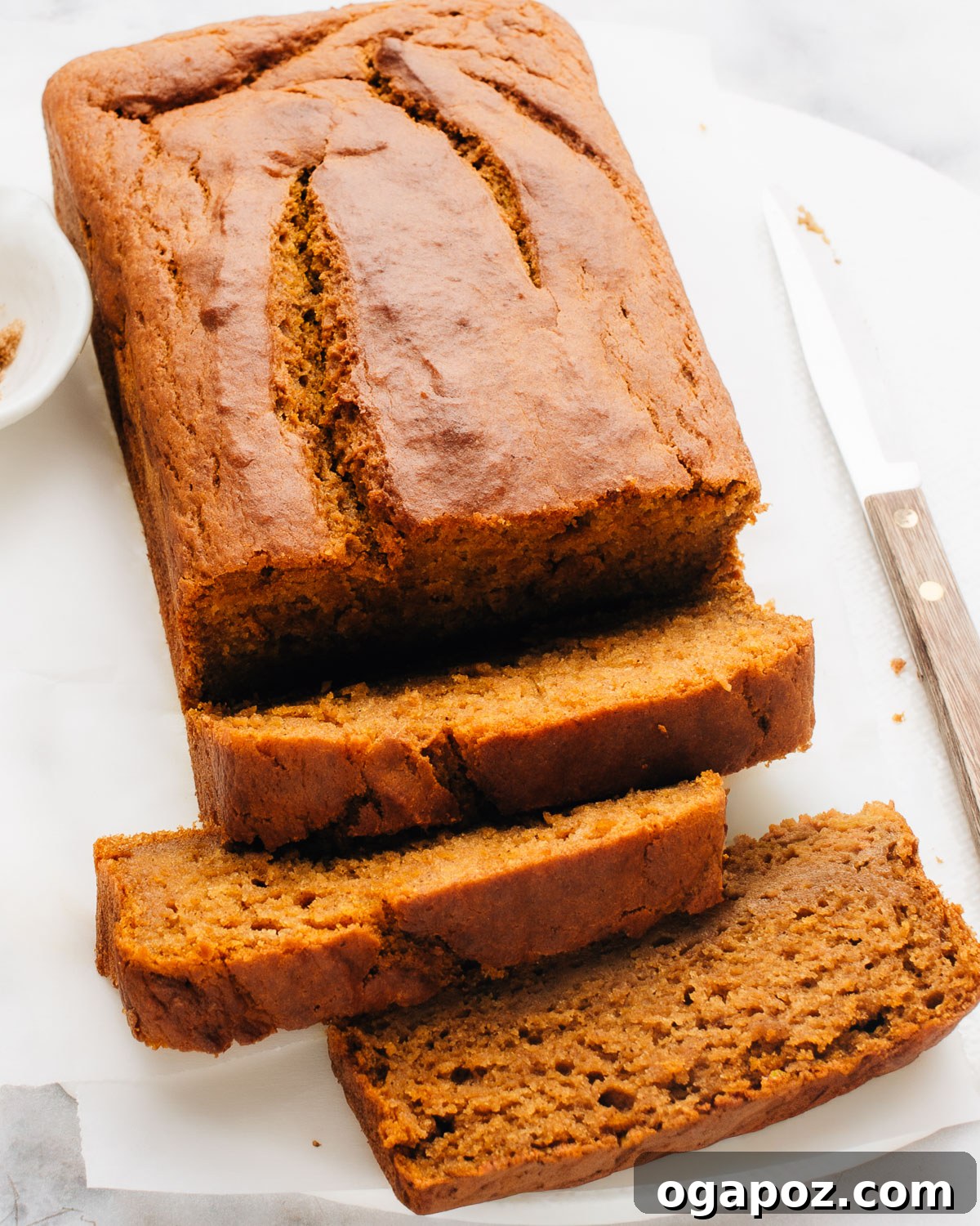 Velvety Soft and Moist Pumpkin Banana Bread 2 A freshly baked loaf of moist pumpkin banana bread, sliced and ready to serve.