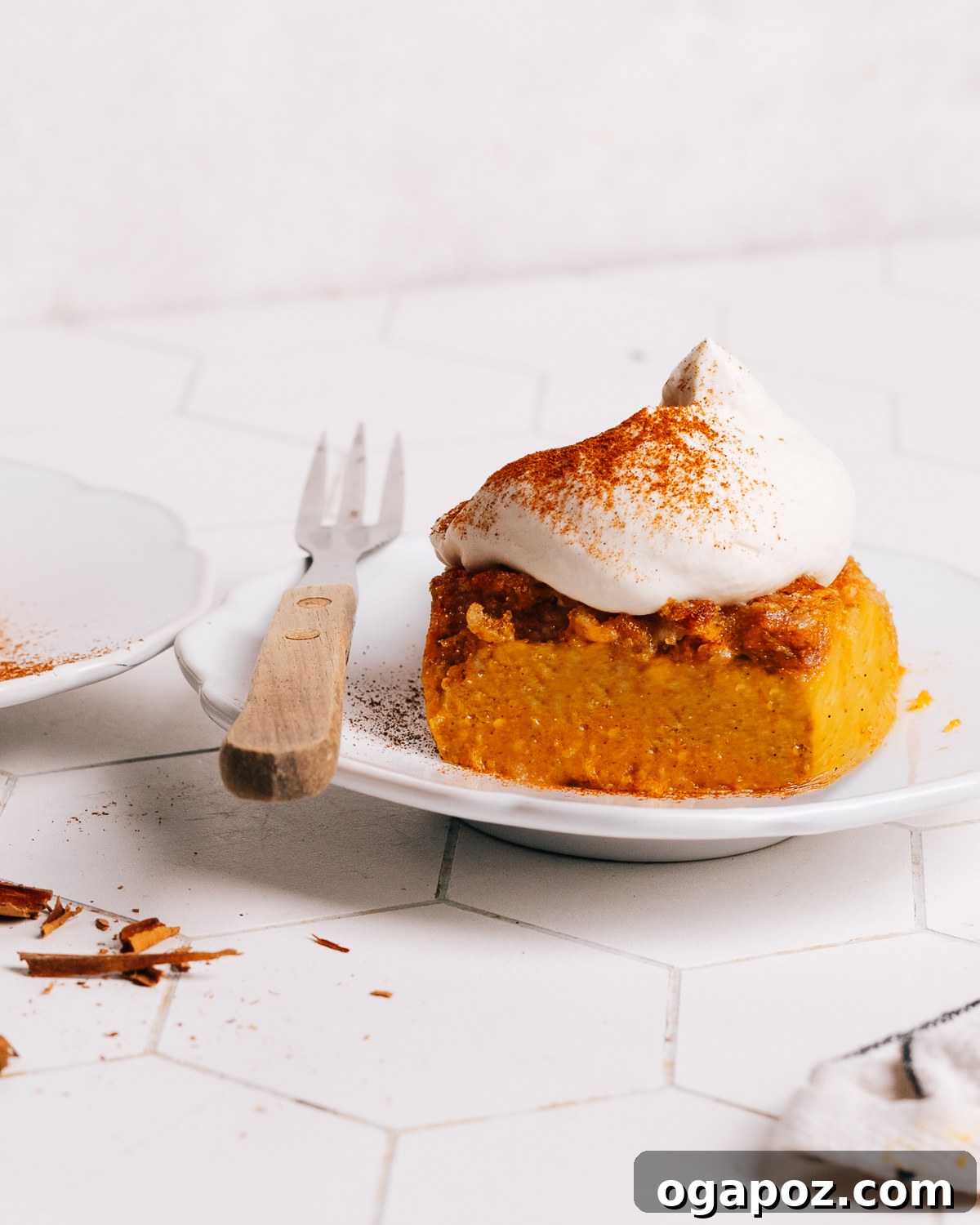 Pumpkin Dump Cake topped generously with fluffy whipped cream, ready to be served during a fall celebration.
