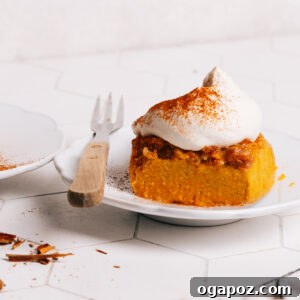 Pumpkin Dump Cake dessert recipe topped with whipped cream.