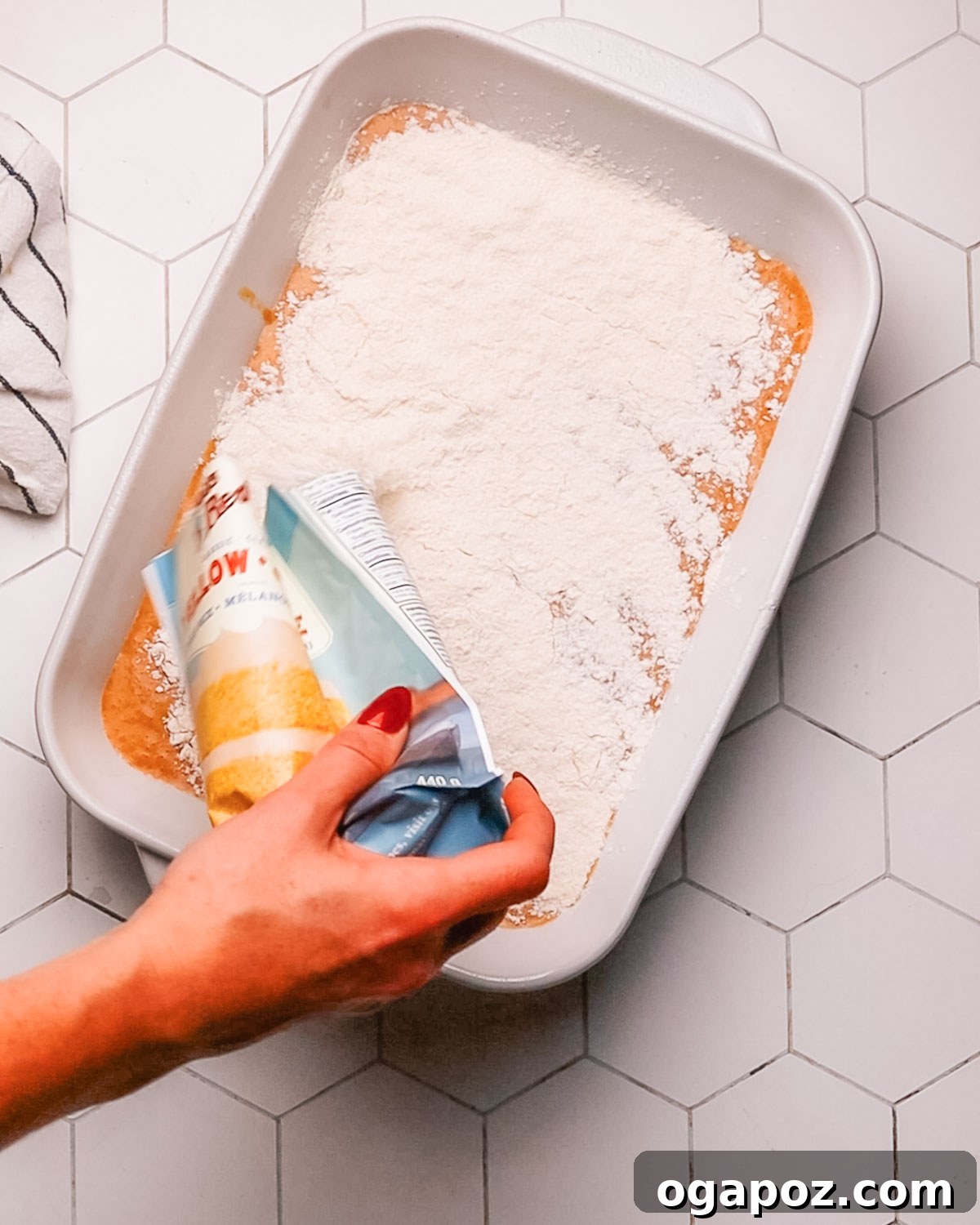 Step-by-step image showing melted butter being drizzled over the dry cake mix layer in a baking pan, preparing Pumpkin Dump Cake for baking.