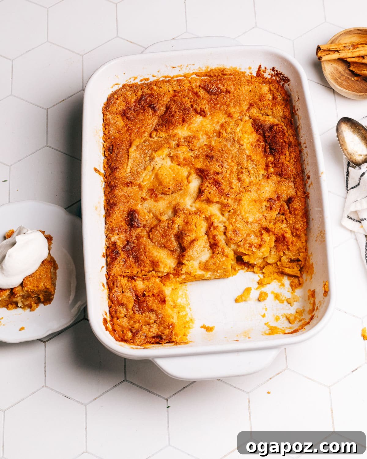 A close-up shot of a single slice of Pumpkin Dump Cake, showcasing its creamy pumpkin layer and crisp, golden cake mix topping.