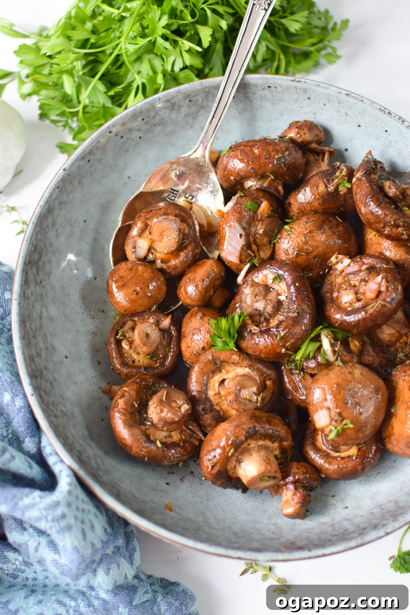 Caramelized Balsamic Roasted Mushrooms 2 Roasted Balsamic Mushrooms with spoon in blue bowl.