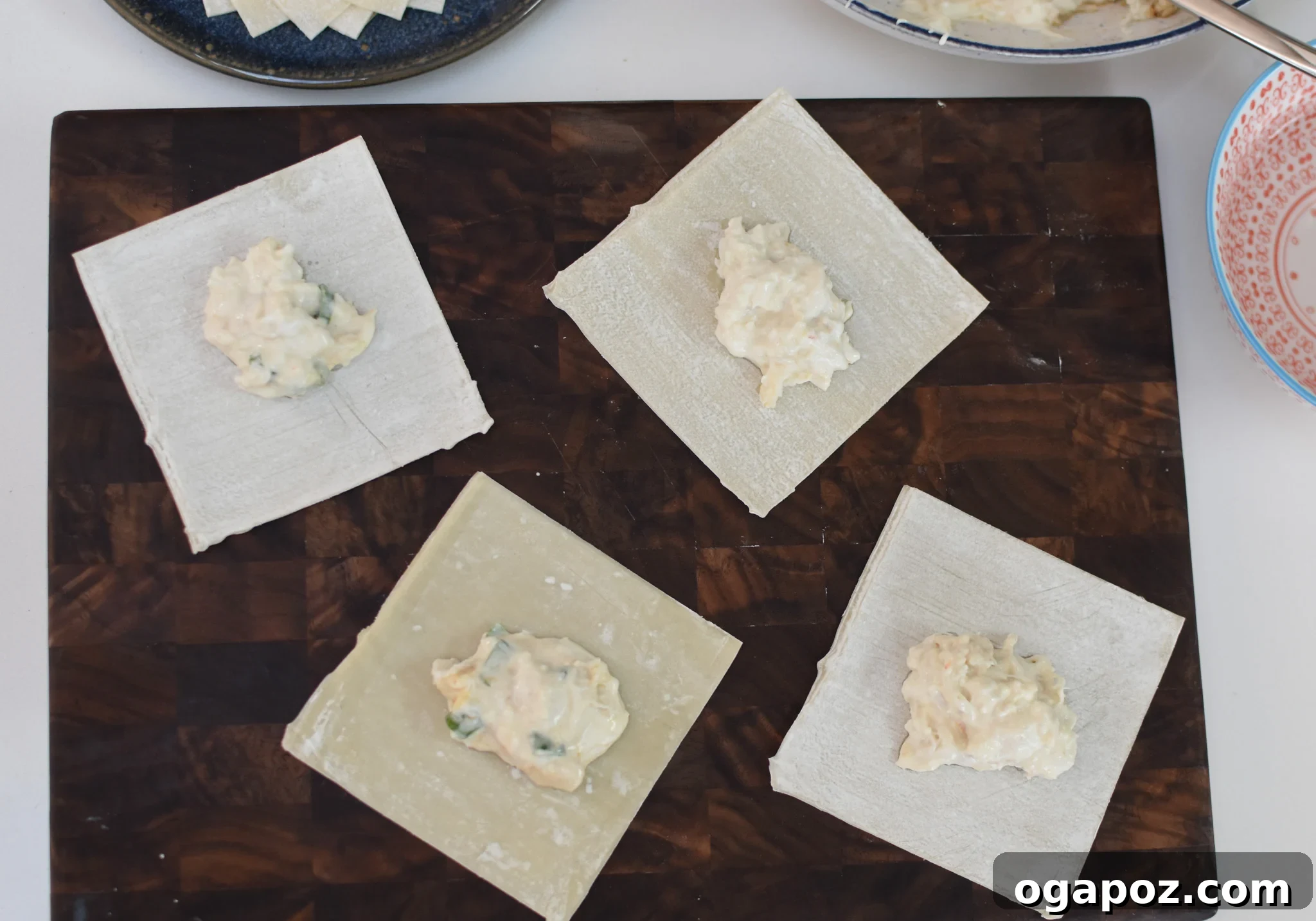 Crispy Air Fryer Crab Rangoon 6 A wonton wrapper with a dollop of crab mixture in the center, prepared for folding.