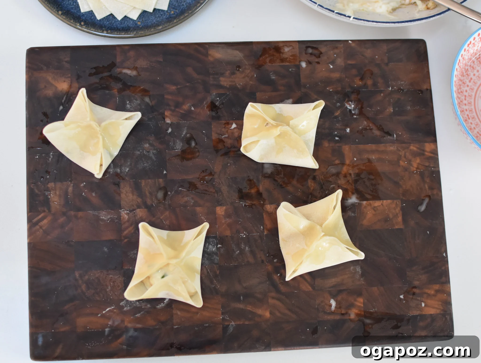 Crispy Air Fryer Crab Rangoon 7 Several wonton wrappers, expertly folded into the classic crab rangoon star shape, ready for air frying.