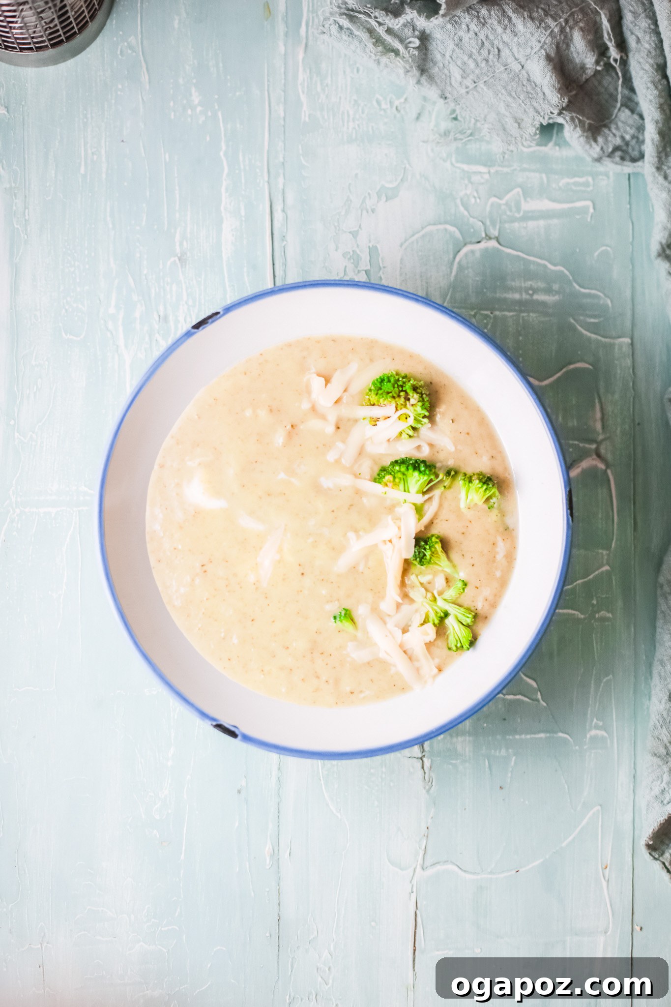 Velvety Instant Pot Broccoli Soup 2 A vibrant bowl of creamy Instant Pot Broccoli Soup garnished with fresh herbs, ready to be enjoyed.