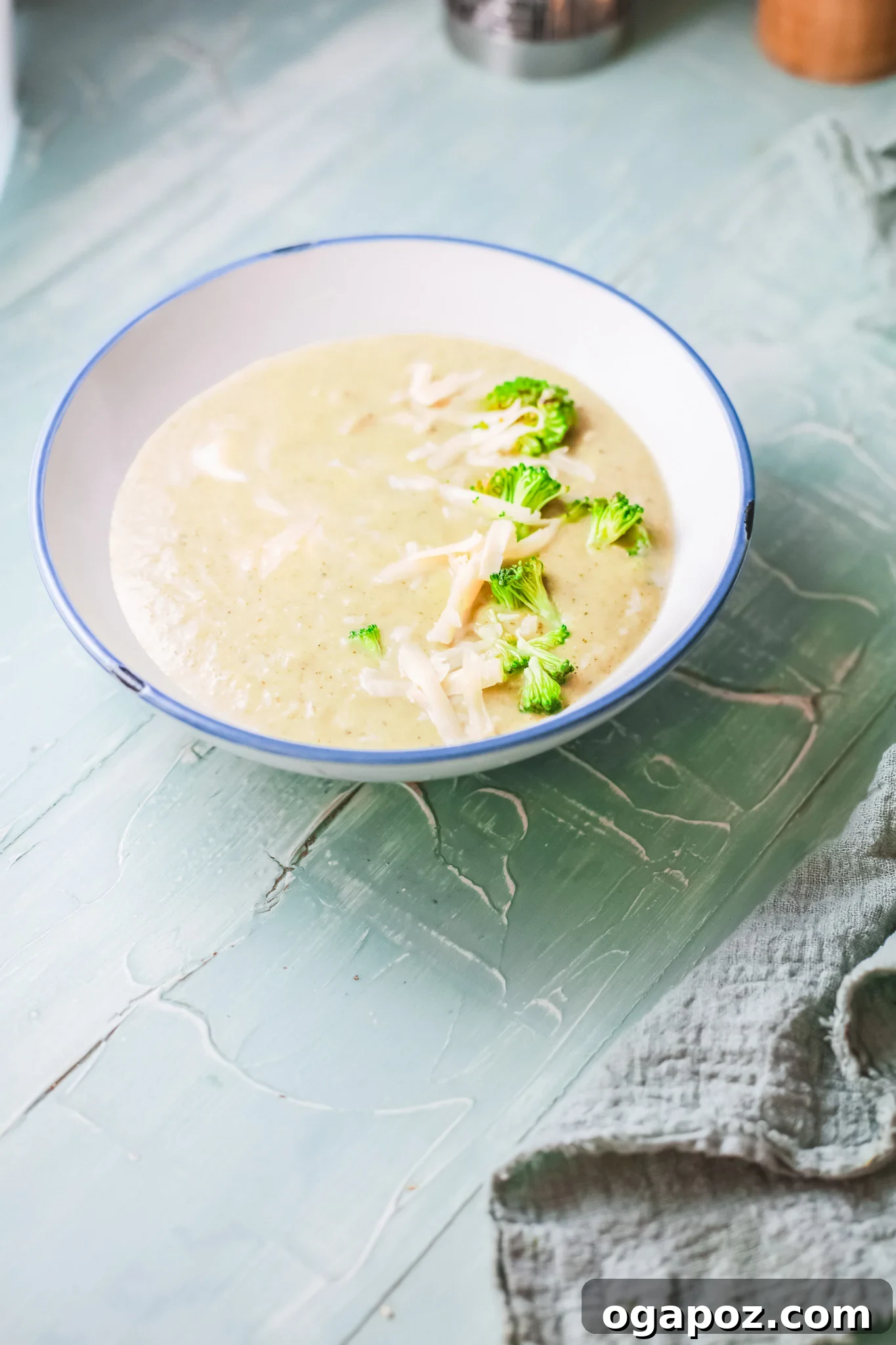 Velvety Instant Pot Broccoli Soup 3 A close-up of fresh broccoli florets, onion, garlic, and cheese, highlighting the quality ingredients for Instant Pot Broccoli Soup.