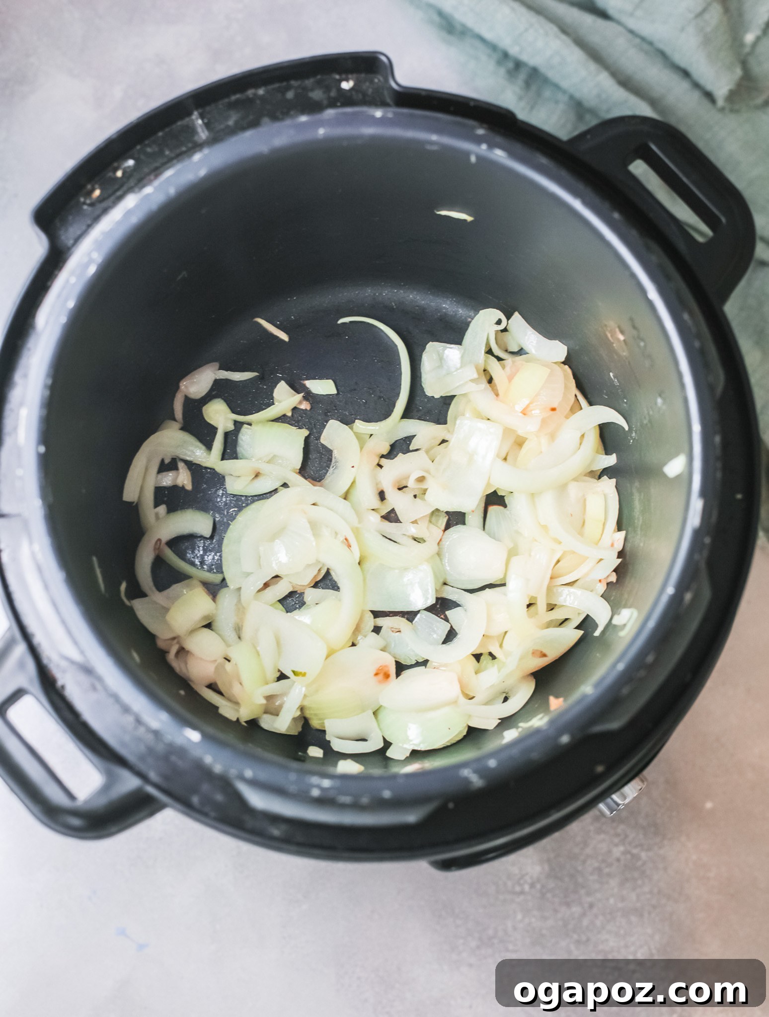 Velvety Instant Pot Broccoli Soup 4 Sliced onions gently sautéing in an Instant Pot, building the aromatic base for the creamy broccoli soup.