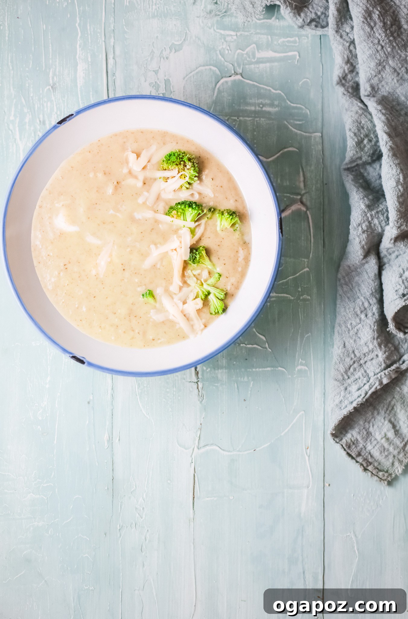 Velvety Instant Pot Broccoli Soup 7 Creamy Instant Pot Broccoli Soup with melted cheese and a swirl of cream, ready to be served and garnished.