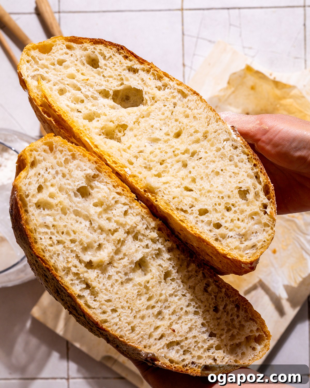Effortless Dutch Oven Perfection 3 Cross-section view of a freshly baked no-knead Dutch oven bread loaf, revealing its open, airy texture and golden crust.