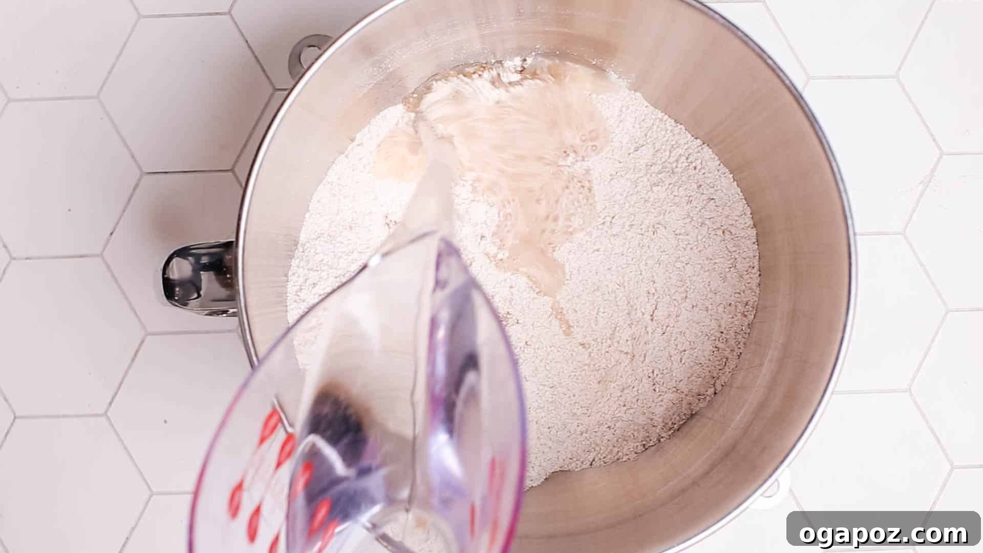 Effortless Dutch Oven Perfection 4 Hands adding warm water to a bowl of flour, starting the no-knead bread dough.