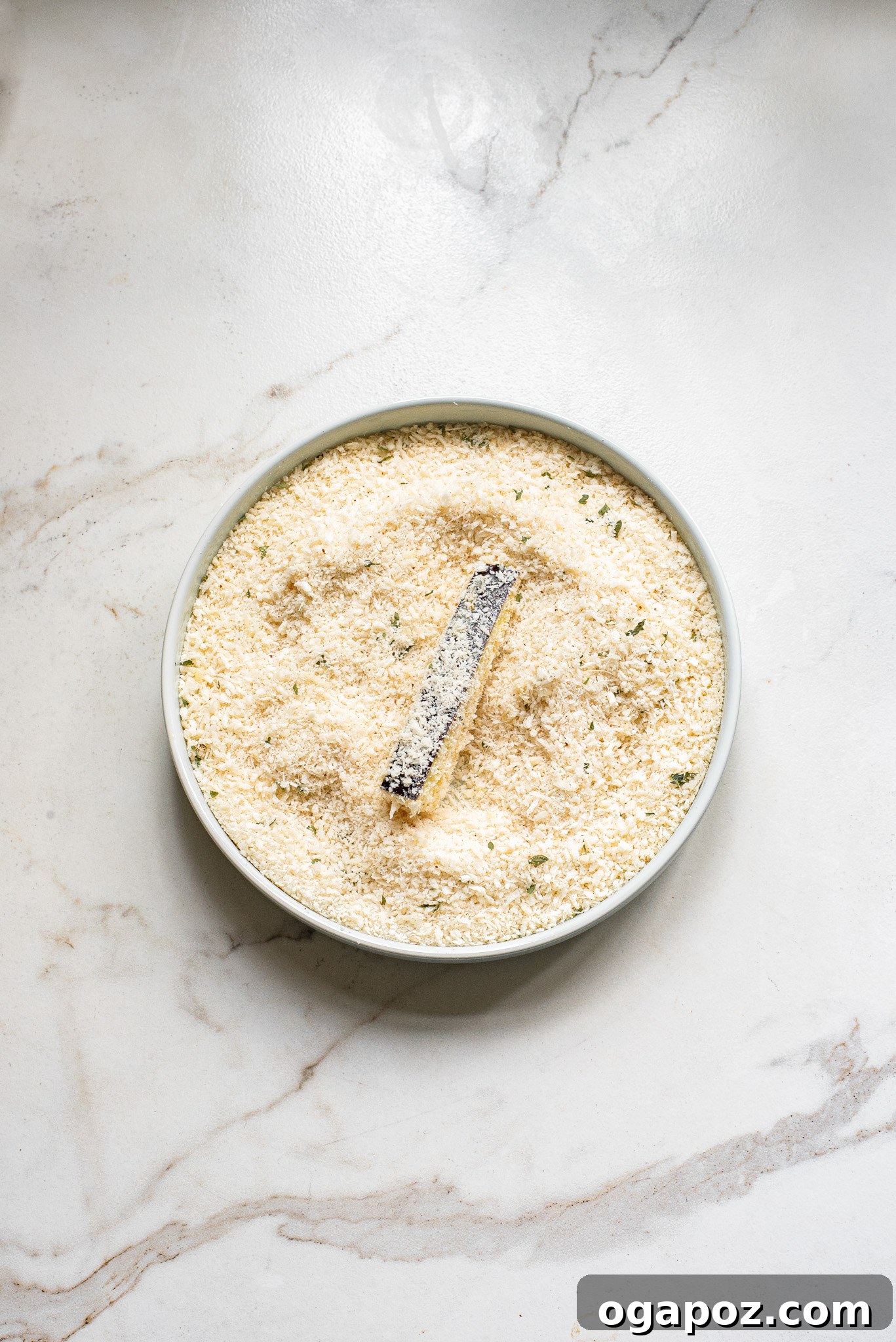Irresistible Air Fryer Eggplant Fries 7 Coated eggplant fries ready for cooking in the air fryer basket for Air Fryer Eggplant Fries Recipe.
