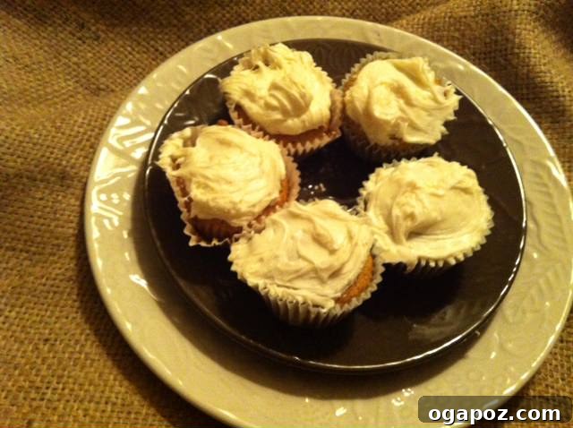 Five Cupcakes A batch of five freshly baked carrot cupcakes cooling on a wire rack, waiting for frosting