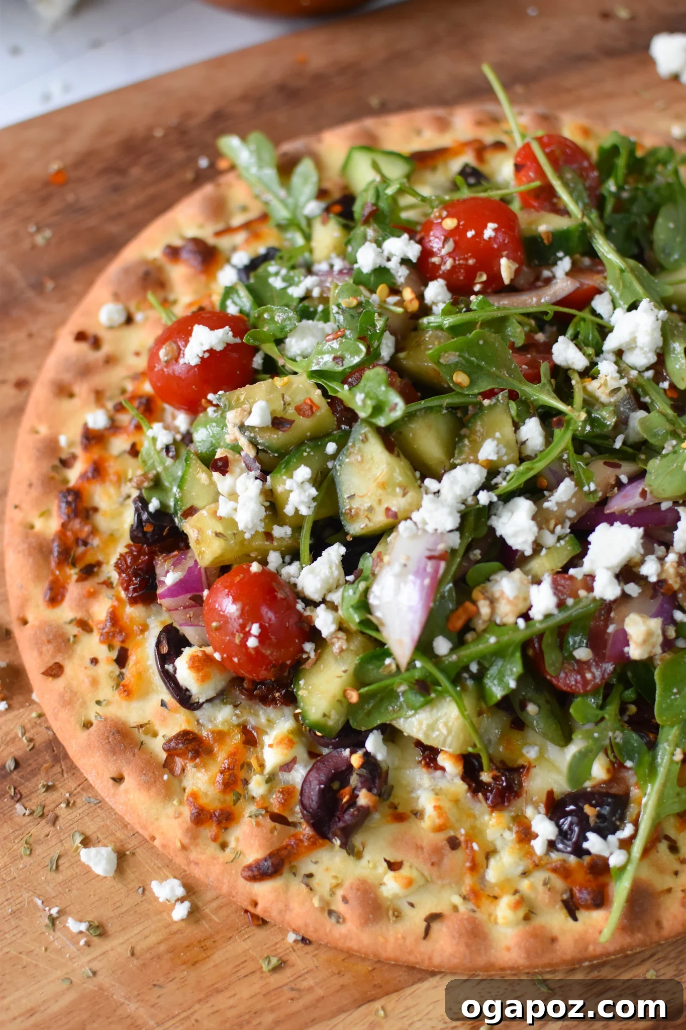 Aegean Delight Pizza 7 Completed Greek Pizza with fresh salad topping, ready to be sliced and served.