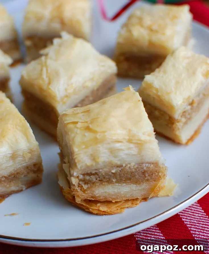 Mastering the Art of Baklava 3 A meticulously prepared baking tray, showcasing layers of phyllo dough generously brushed with melted butter, ready for the nut filling.