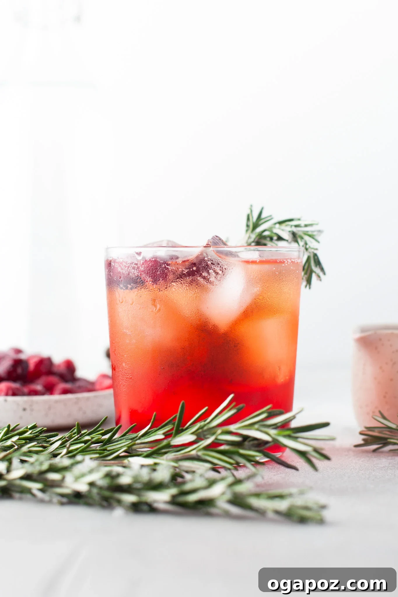 A Cranberry Aperol Spritz cocktail served in a stylish short glass, ready to be enjoyed.