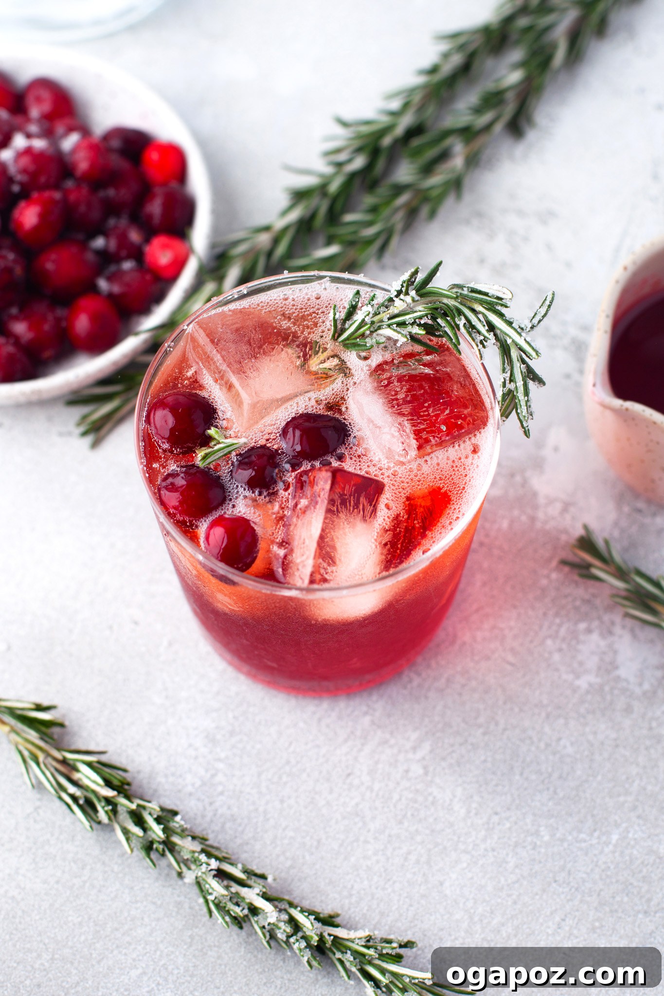 Cranberry Aperol Spritz garnished with fresh rosemary, ready to be served as an inviting aperitif.