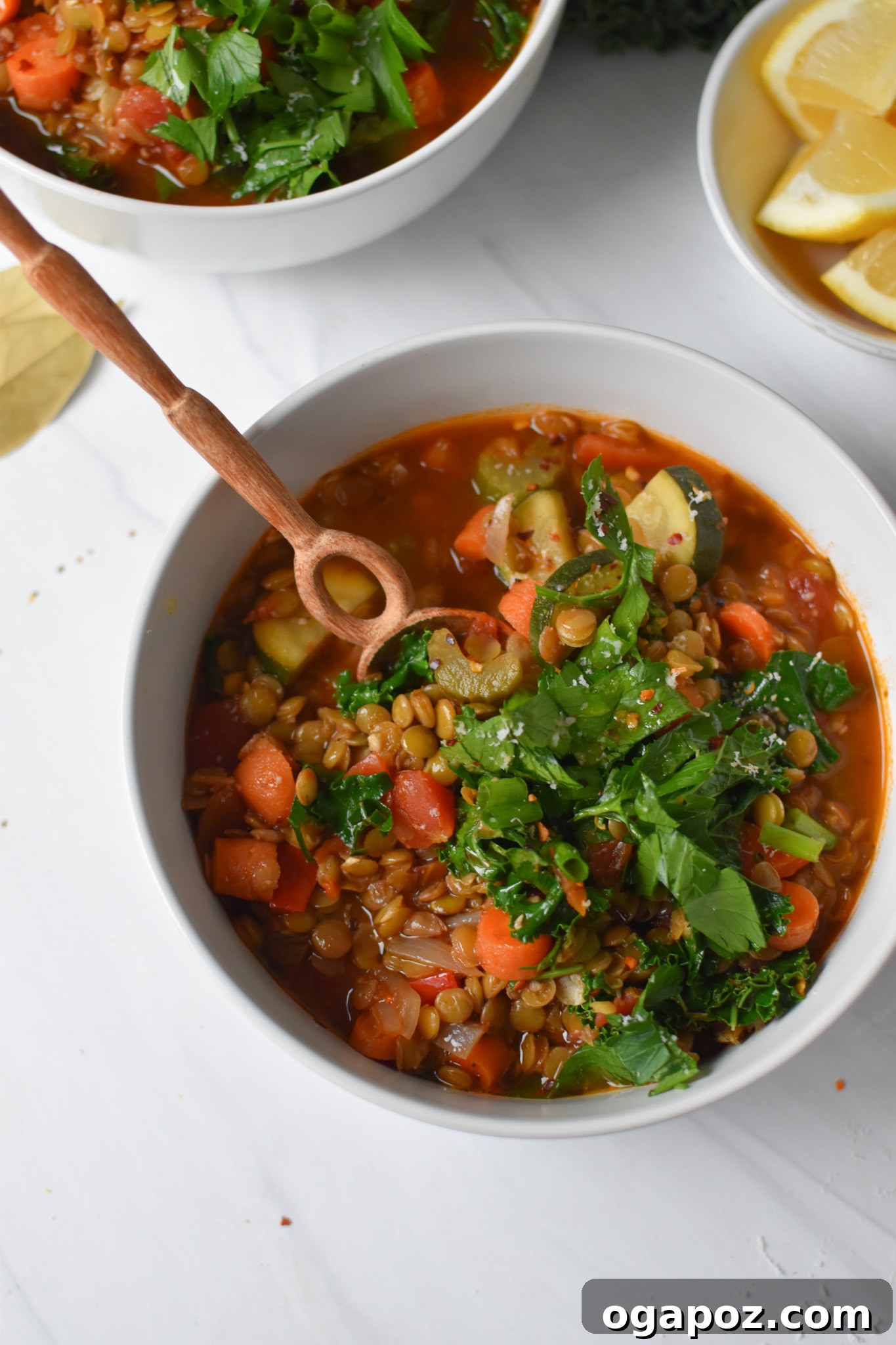 Hearty Tuscan Lentil Stew 6 A close-up of Italian Style Lentil Soup in a pot, with a wooden spoon stirring the rich, hearty mixture.