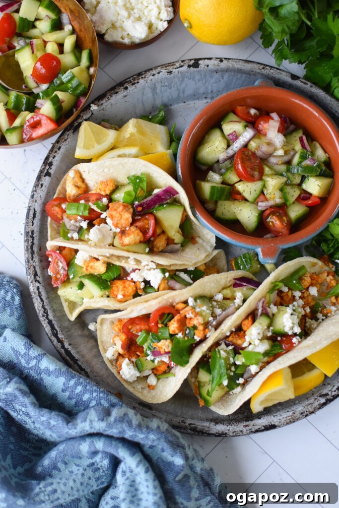 Mediterranean-Inspired Tofu Tacos 2 A beautifully plated Mediterranean Style Tofu Taco on a blue plate, garnished with fresh herbs and a vibrant salsa.