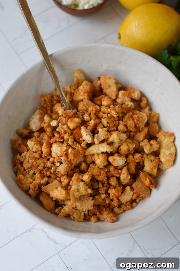 Mediterranean-Inspired Tofu Tacos 5 Seasoned and crumbled Mediterranean Style Tofu in a bowl, ready for baking.