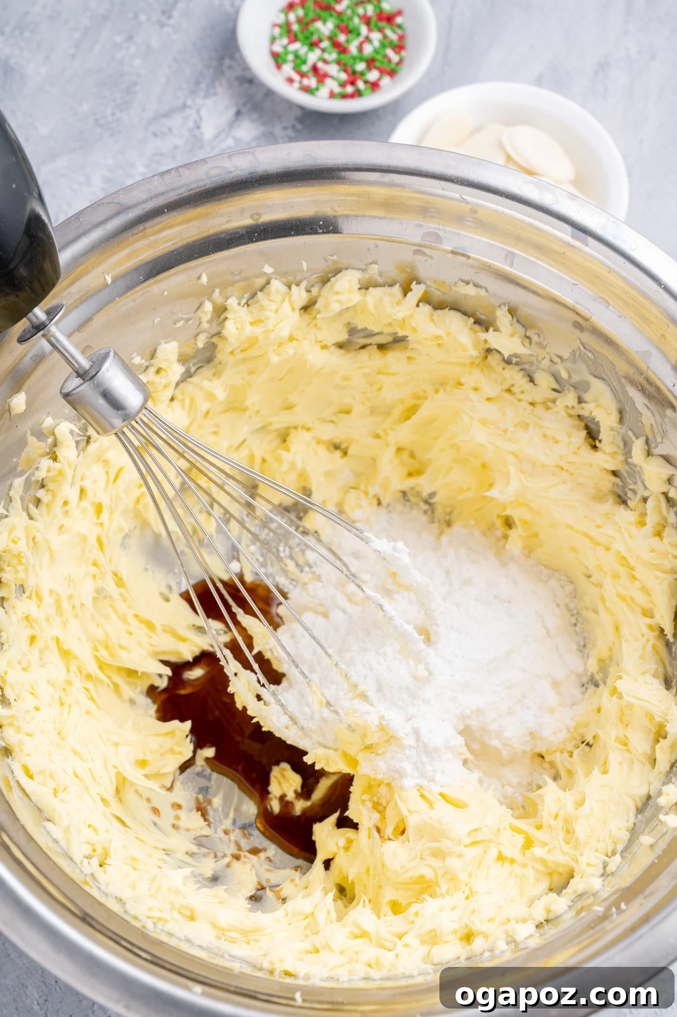 Buttery Christmas Shortbread Bliss 5 Butter, vanilla extract, and powdered sugar creaming together in a bowl, the initial step for Christmas Shortbread Cookies.