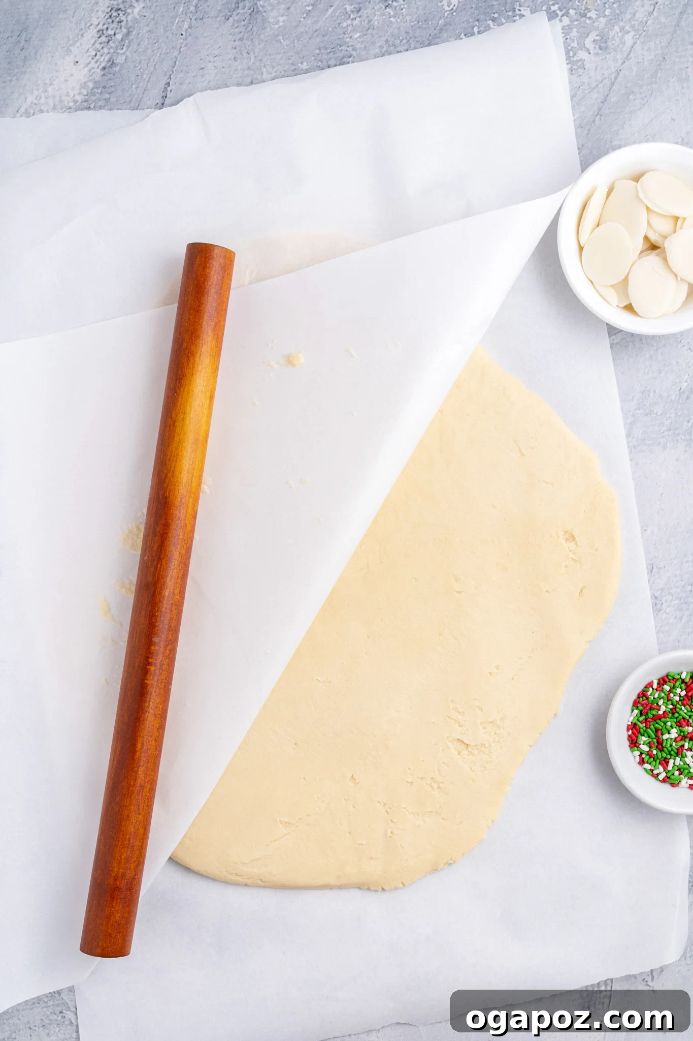 Buttery Christmas Shortbread Bliss 7 The cookie dough being expertly rolled between two sheets of parchment paper, ensuring an even thickness.