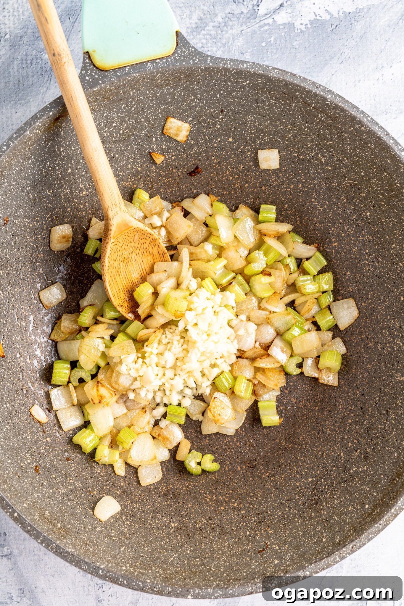 Onions and celery sautéing in a skillet, for Crock Pot Beef Stew.