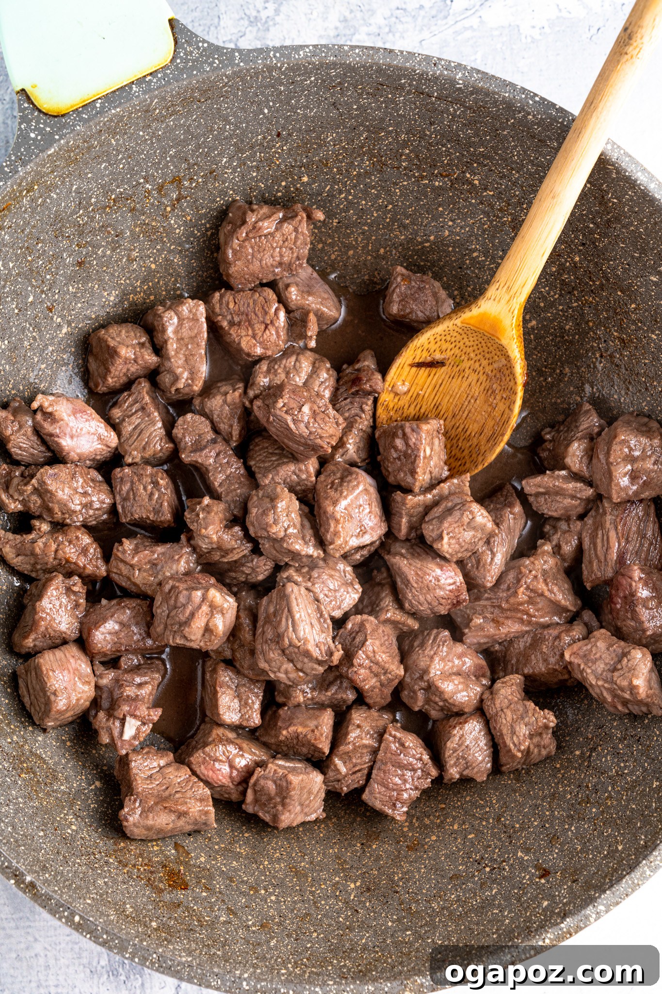 Close-up of perfectly browned beef pieces in a skillet, ready for the slow cooker.