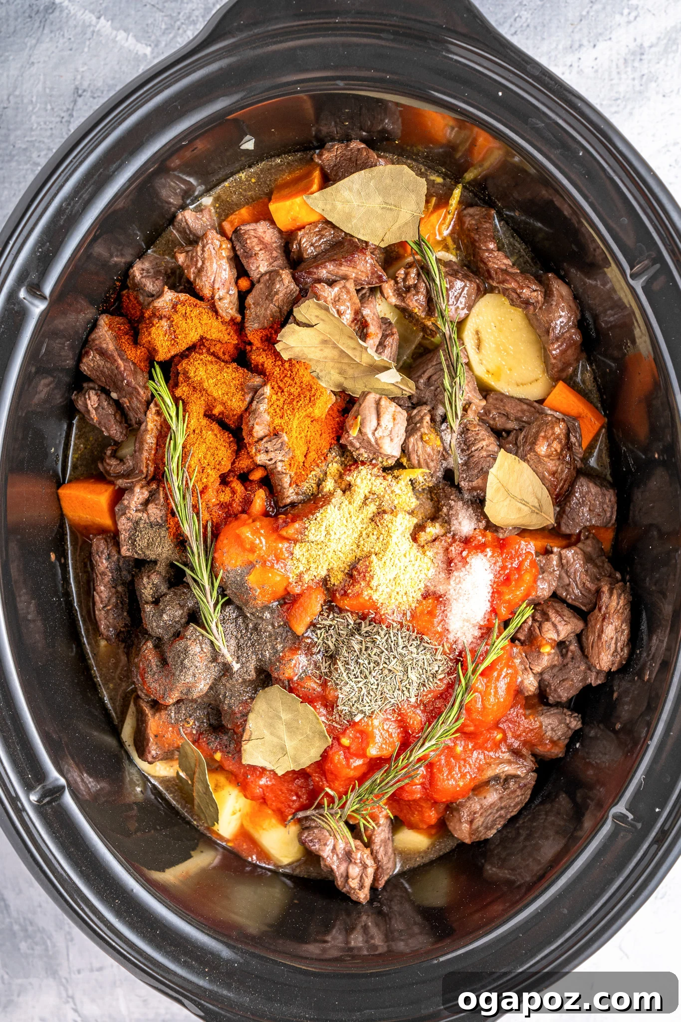 All ingredients for Crock Pot Beef Stew combined in a slow cooker, ready for cooking.