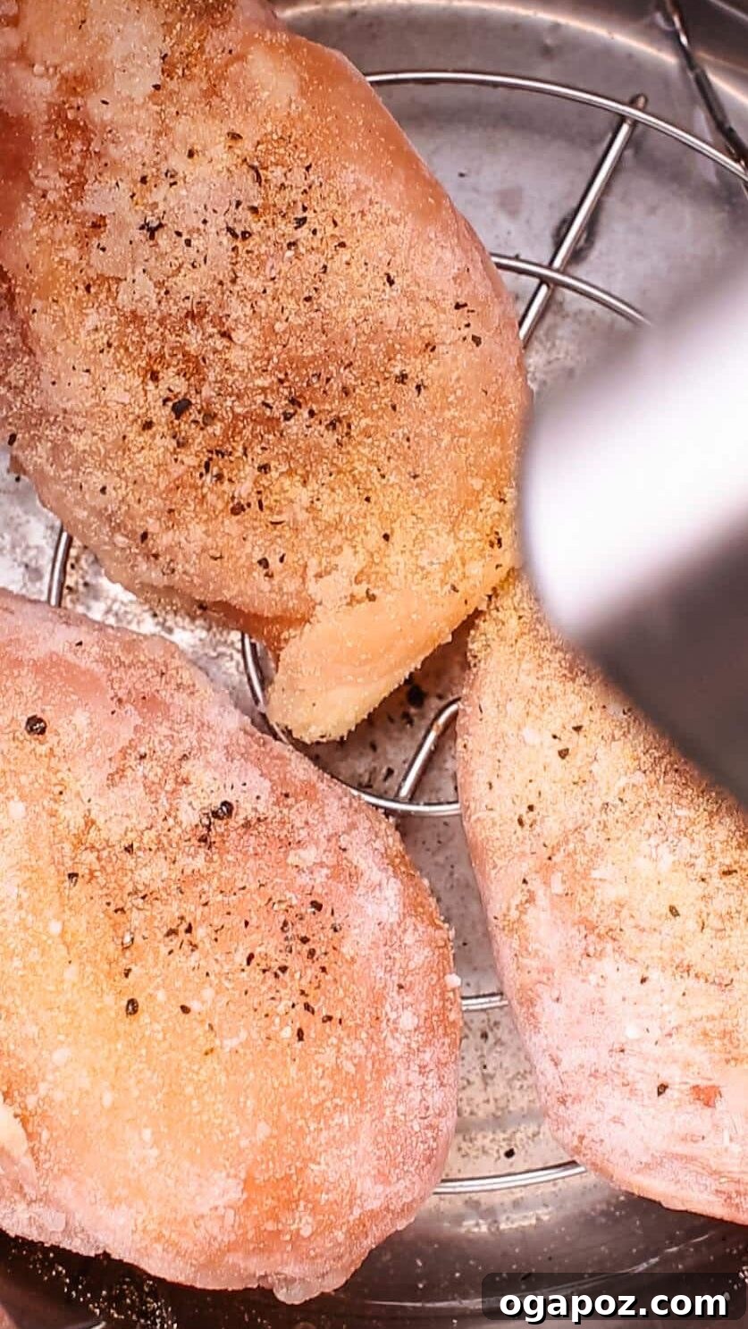 Lemony Slow Cooker Chicken 4 Seasoning chicken breasts with black pepper and salt.
