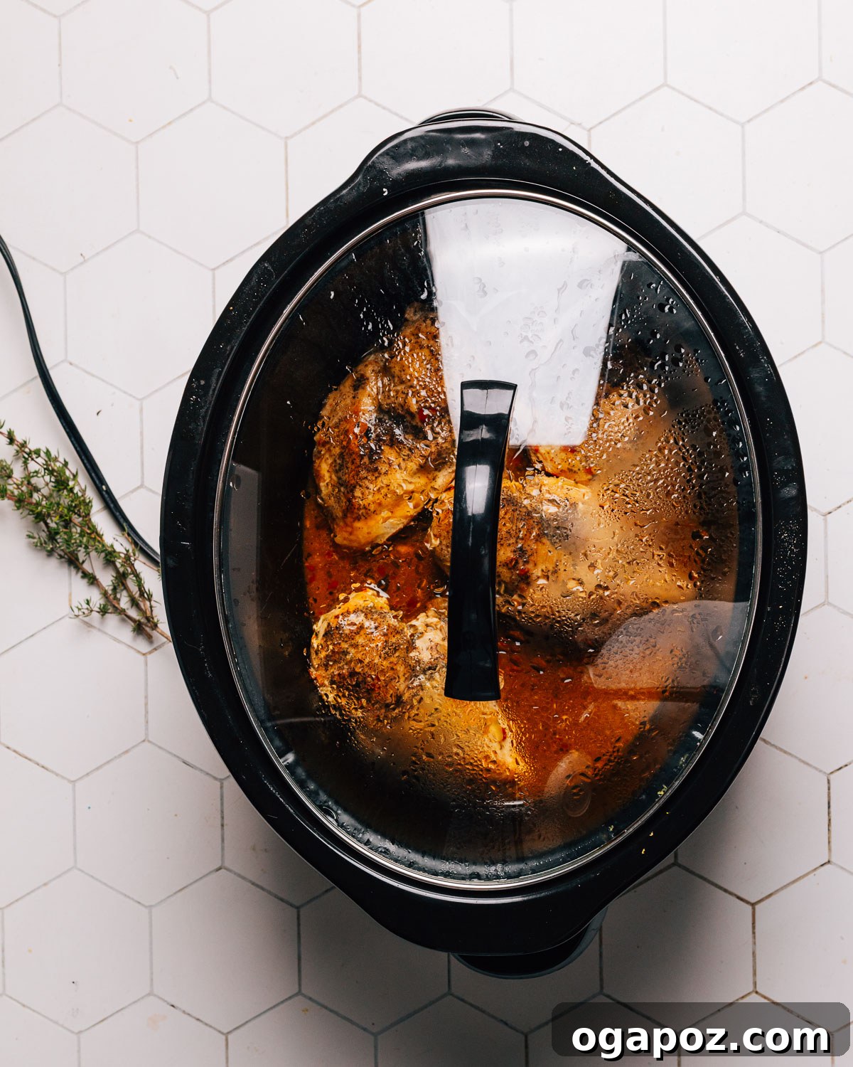 Lemony Slow Cooker Chicken 6 Chicken breasts nested in lemon sauce in a crockpot with butter on top.