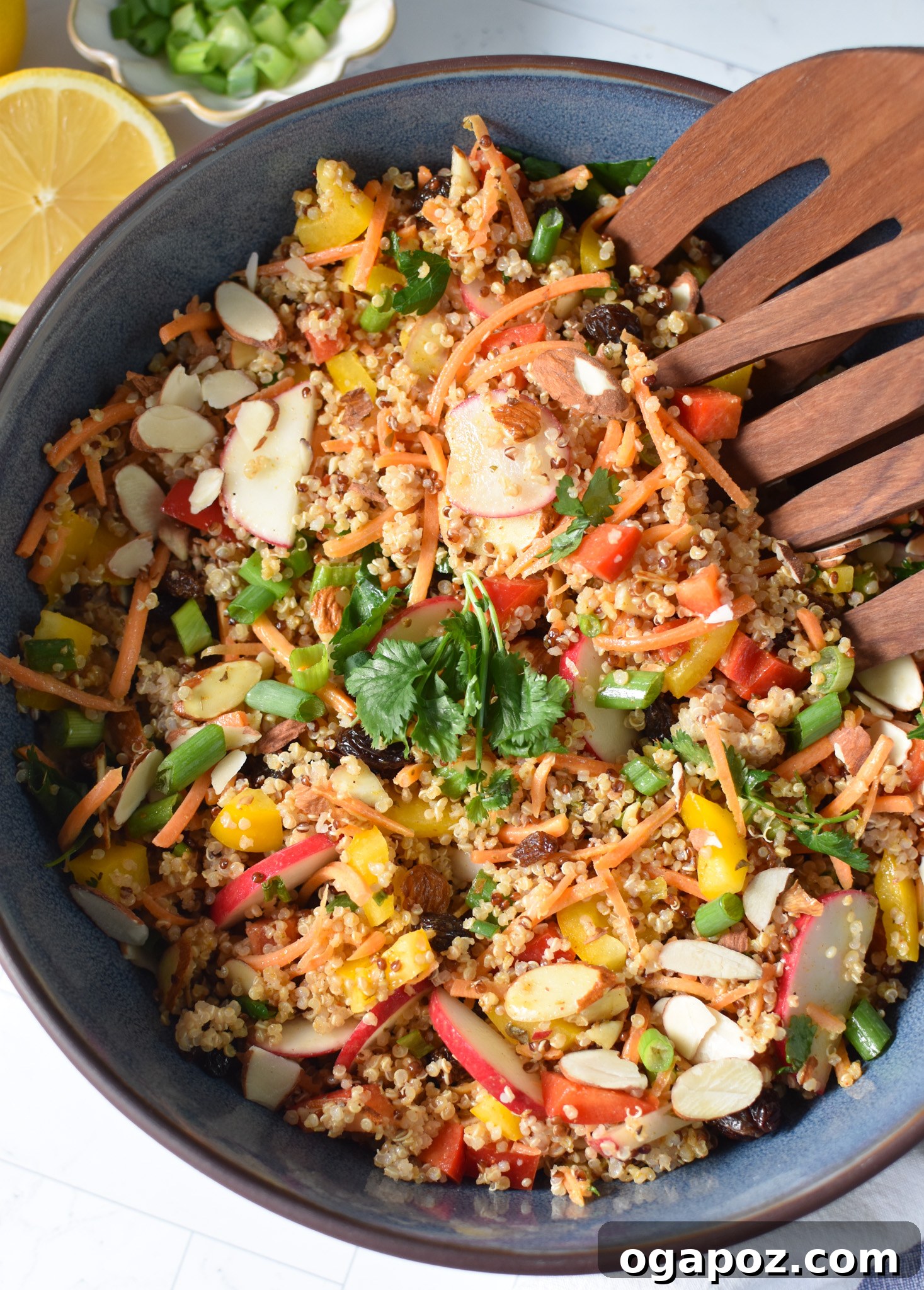Close-up shot of Curried Quinoa Salad in a blue bowl, highlighting the texture of quinoa and diced vegetables.