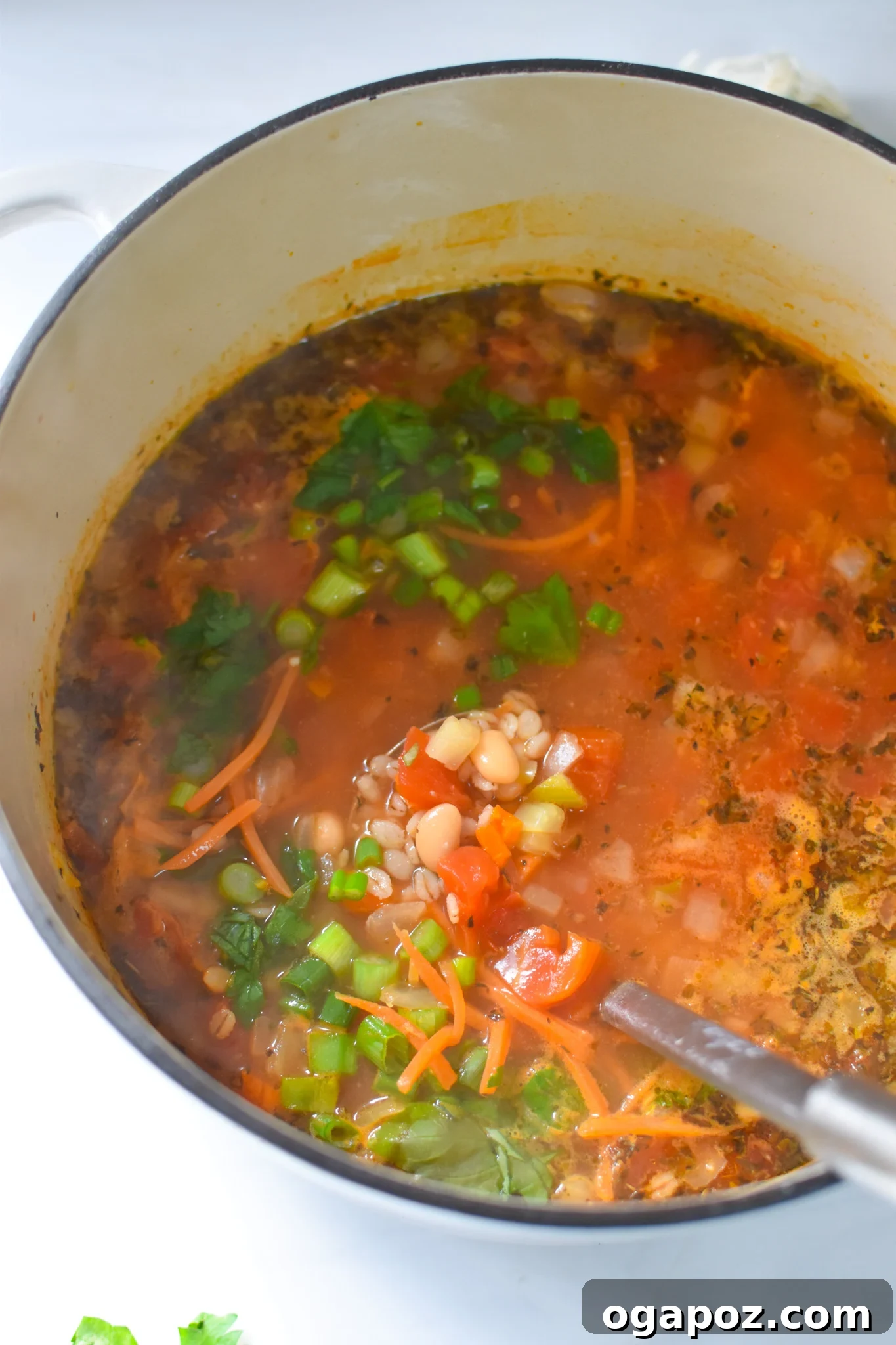 Vegetable Barley Soup simmering in a large pot on the stove, ready for the final touches.