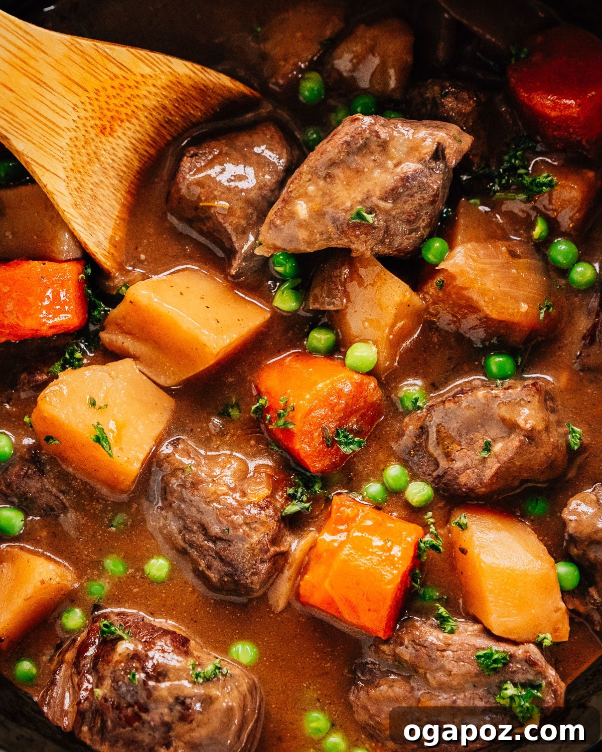 Pressure Cooker Beef Stew in Instant Pot with a wooden spoon, showcasing its rich texture and enticing aroma.