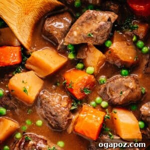 Pressure Cooker Beef Stew in Instant Pot with a wooden spoon, ready to be served.