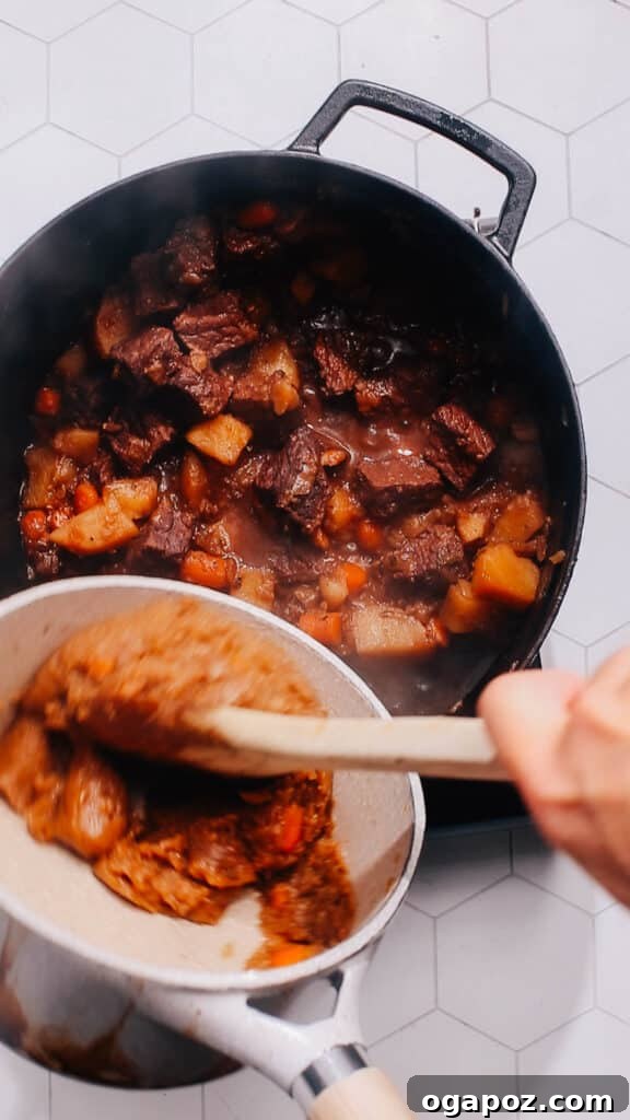 Step 5: Incorporating the roux into the hot broth to thicken the stew into a rich gravy.